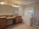 Primary bathroom featuring granite counters, dual sinks, a garden tub, and a separate shower at 3918 Sw 57Th Ave, Ocala, FL 34474