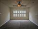 Spacious bedroom with neutral carpet, decorative ceiling fan, and plantation shutters for optimal privacy at 3918 Sw 57Th Ave, Ocala, FL 34474