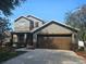 Two-story home featuring a large two car garage, neutral paint scheme, and well-maintained landscaping at 3918 Sw 57Th Ave, Ocala, FL 34474