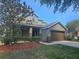 Two-story home featuring an attached two-car garage, neutral paint scheme, and mature landscaping at 3918 Sw 57Th Ave, Ocala, FL 34474