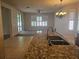 Open-concept kitchen flowing into the living area, featuring granite countertops and tile flooring at 3918 Sw 57Th Ave, Ocala, FL 34474