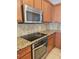 Modern kitchen with stainless steel appliances, granite countertops, and tile backsplash at 3918 Sw 57Th Ave, Ocala, FL 34474