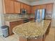 Spacious kitchen with stainless steel appliances, granite countertops, and a center island at 3918 Sw 57Th Ave, Ocala, FL 34474