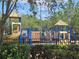 Community playground with slides, climbing structures, and a safety fence at 3918 Sw 57Th Ave, Ocala, FL 34474