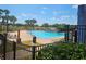 Community pool with palm trees and plenty of lounge chairs to enjoy the sun at 3918 Sw 57Th Ave, Ocala, FL 34474