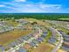 An aerial shot emphasizes the home's location in a neighborhood surrounded by vast natural areas at 4411 Nw 53Rd Ct, Ocala, FL 34482