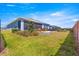 The spacious backyard boasts a cozy patio with seating and a screened enclosure, perfect for enjoying the outdoors at 4411 Nw 53Rd Ct, Ocala, FL 34482