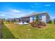 This spacious backyard features a manicured lawn, a screened enclosure, and a patio with seating for outdoor enjoyment at 4411 Nw 53Rd Ct, Ocala, FL 34482