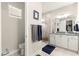 Bright bathroom featuring a window, white cabinets, and a glass-enclosed shower at 4411 Nw 53Rd Ct, Ocala, FL 34482
