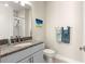Charming bathroom features granite countertops, complemented by neutral walls and a decorative seascape painting at 4411 Nw 53Rd Ct, Ocala, FL 34482