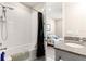 Bright bathroom features a shower-tub combo and granite vanity, with a glimpse into an adjacent bedroom at 4411 Nw 53Rd Ct, Ocala, FL 34482