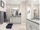 Bright bathroom featuring double sinks, a large mirror, and a walk-in shower at 4411 Nw 53Rd Ct, Ocala, FL 34482
