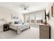 Inviting bedroom with three windows, a ceiling fan, and neutral decor at 4411 Nw 53Rd Ct, Ocala, FL 34482