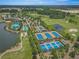 Aerial view of a community with a pool, tennis courts, clubhouse and golf course at 4411 Nw 53Rd Ct, Ocala, FL 34482