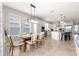 Dining area with chandelier, large windows, and open concept layout to kitchen at 4411 Nw 53Rd Ct, Ocala, FL 34482