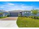 Well-maintained single-story home with a brick driveway, manicured lawn, and inviting curb appeal at 4411 Nw 53Rd Ct, Ocala, FL 34482