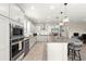 Bright kitchen featuring stainless steel appliances, granite counters, an island, and open concept layout at 4411 Nw 53Rd Ct, Ocala, FL 34482