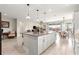 Kitchen island with granite counters, pendant lighting, and open to dining and living spaces at 4411 Nw 53Rd Ct, Ocala, FL 34482