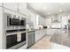 Well-equipped kitchen with granite countertops, stainless steel appliances, and white cabinets at 4411 Nw 53Rd Ct, Ocala, FL 34482