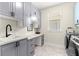 Well-equipped laundry room boasts modern gray cabinetry and a convenient countertop work space at 4411 Nw 53Rd Ct, Ocala, FL 34482