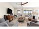 Inviting living room featuring a comfortable sectional sofa, decorative rug, and a ceiling fan at 4411 Nw 53Rd Ct, Ocala, FL 34482