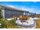 This cozy patio features a screened enclosure, stylish outdoor seating, and lush landscaping for relaxing and entertaining at 4411 Nw 53Rd Ct, Ocala, FL 34482