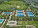 Aerial view of the tennis courts in a well-maintained community with mature trees at 4411 Nw 53Rd Ct, Ocala, FL 34482
