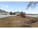 Spacious backyard with a playset, partially covered patio, and fence at 4624 Se 32Nd Pl, Ocala, FL 34480