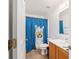 Bathroom featuring a single sink vanity, toilet, mirror and a Llama-themed shower curtain at 4624 Se 32Nd Pl, Ocala, FL 34480