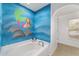 Bathroom with blue walls painted with a mermaid mural at 4624 Se 32Nd Pl, Ocala, FL 34480