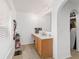 Bathroom with wooden cabinets, white countertop and arched doorway at 4624 Se 32Nd Pl, Ocala, FL 34480
