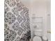 Toilet next to a metal rack holding towels at 4624 Se 32Nd Pl, Ocala, FL 34480