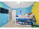Bright bedroom featuring a bunk bed and playful painted walls at 4624 Se 32Nd Pl, Ocala, FL 34480