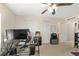Bedroom featuring neutral walls, ceiling fan and a variety of items, including large computer and audio amplifiers at 4624 Se 32Nd Pl, Ocala, FL 34480
