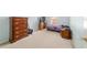 Bedroom with dresser, bed, desk, and window providing natural light, creating a cozy atmosphere at 4624 Se 32Nd Pl, Ocala, FL 34480