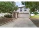 Charming two-story home featuring a two-car garage, arched entry, and well-maintained landscaping at 4624 Se 32Nd Pl, Ocala, FL 34480