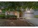 Charming home featuring an arched entryway, well-manicured bushes, and a two-car garage at 4624 Se 32Nd Pl, Ocala, FL 34480