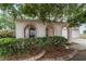 Arched front porch entry with trimmed hedges and low maintenance landscape beds at 4624 Se 32Nd Pl, Ocala, FL 34480