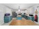 Bright eat-in kitchen features stainless appliances, white counters, and blue lower cabinets at 4624 Se 32Nd Pl, Ocala, FL 34480