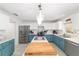Bright eat-in kitchen features stainless appliances, white counters, and blue lower cabinets at 4624 Se 32Nd Pl, Ocala, FL 34480