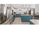 Bright eat-in kitchen with stainless appliances, a center island, and white and blue cabinetry at 4624 Se 32Nd Pl, Ocala, FL 34480