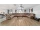 Spacious living room featuring a large sectional sofa and wood floors at 4624 Se 32Nd Pl, Ocala, FL 34480