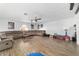 Bright living room featuring wood floors, a large sectional, and ceiling fan at 4624 Se 32Nd Pl, Ocala, FL 34480