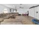 Large, bright living room with wood floors, sectional sofa, and ceiling fan at 4624 Se 32Nd Pl, Ocala, FL 34480