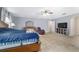 Spacious main bedroom featuring carpet floors, ceiling fan and a sitting area with recliner at 4624 Se 32Nd Pl, Ocala, FL 34480