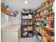Organized pantry with shelving, cabinets, and freezer at 4624 Se 32Nd Pl, Ocala, FL 34480