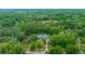 Secluded estate nestled in a dense forest, boasting a private pool and sprawling grounds for ultimate privacy at 4710 Se 30Th Ct, Ocala, FL 34480