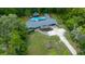 Expansive property features a pool, lush landscaping, and a well-maintained residence in a serene, wooded setting at 4710 Se 30Th Ct, Ocala, FL 34480