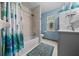 Comfortable bathroom with a tub, shower, and blue accents at 4710 Se 30Th Ct, Ocala, FL 34480