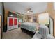 Bedroom featuring a bed, ceiling fan, stained-glass window, and a TV at 4710 Se 30Th Ct, Ocala, FL 34480